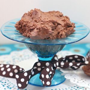 Blue glass bowl filled with vegan chocolate mousse.