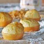 Close up shot of Brazilian Cheese Bread on a floured wooden board.