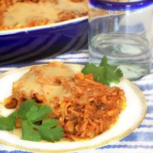 Square photo with baked pasta on a white plate.