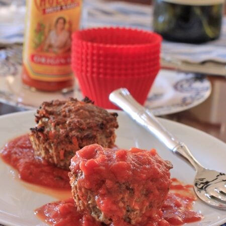 gluten free Meatloaf Muffins on a white plate with marinara sauce