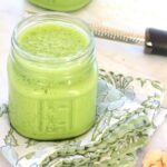 Low FODMAP Pineapple Ginger Kale Smoothie in a glass on a green, blue, and white napkin.