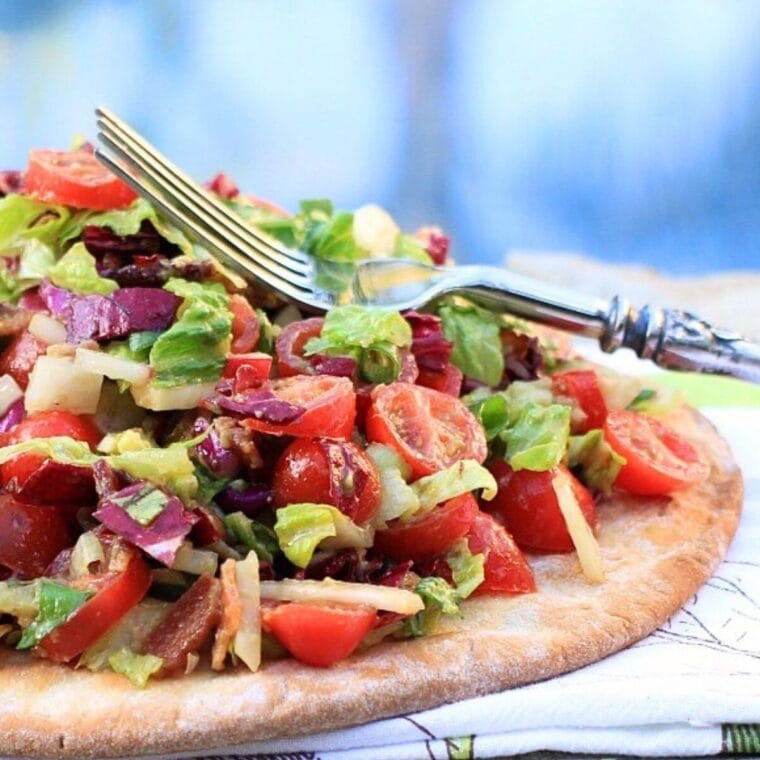 Chopped salad pizza with lots of vegetables on a gluten free crust.