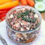 Glass bowl with lentil feta bruschetta dip.