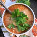 overhead shot of a bowl of vegan lasagna soup topped with fresh parsley.