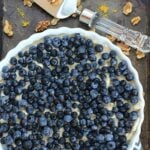 Lemon Ice Cream Pie in a white pie pan topped with fresh blueberries.