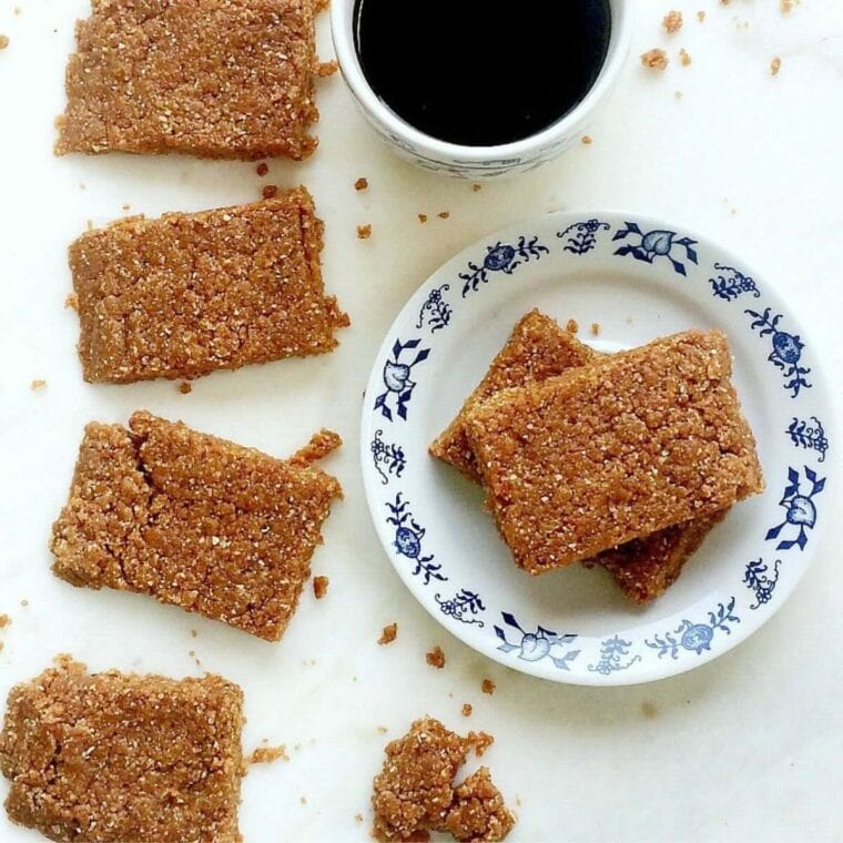 Peanut Butter No Bake Protein Bars on a white tray and a blue and white plate.