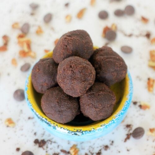 Blue and yellow ceramic bowl filled with chocolate banana flour brownie bites.