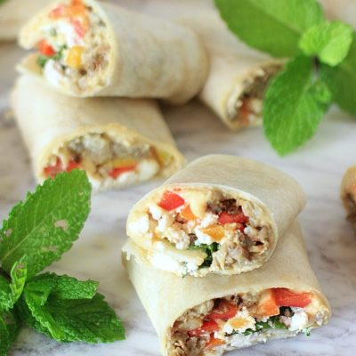 This Sabra Hummus Veggie Wrap is powered with plant based protein + peppers, roasted eggplant, fresh mint, & feta cheese~perfect for a healthy, yet filling lunch, snack, or appetizer! Get the gluten-free recipe at EA Stewart, The Spicy RD #sponsored