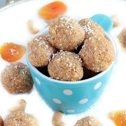 Blue bowl with polkadots filled with apricot energy bites.