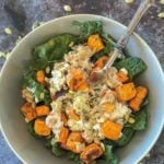 Bowl with kale, roasted sweet potatoes, cottage cheese, and pumpkin seeds.