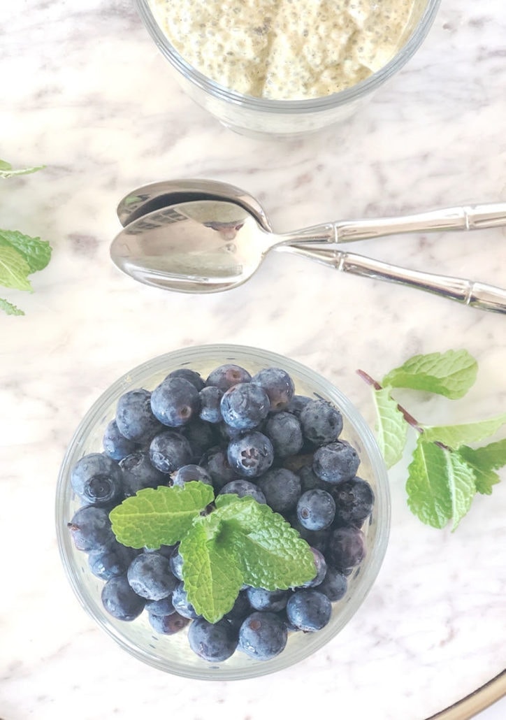 Coconut Chia Pudding on a white marble tray with 2 spoons.
