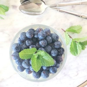 Coconut Chia Pudding in a glass jar with blueberries on top