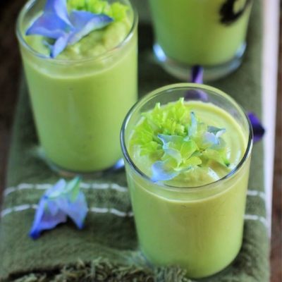 Cucumber Avocado Soup in shot glasses with hydrangeas on top