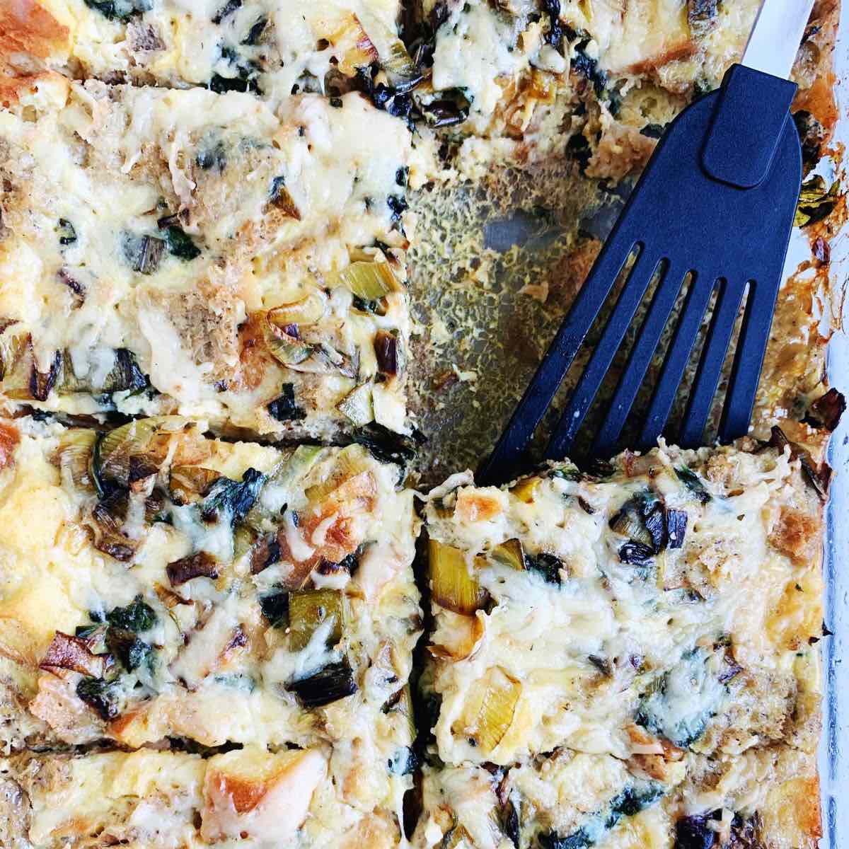 Close up shot of a gluten-free breakfast casserole with a serving spatula.