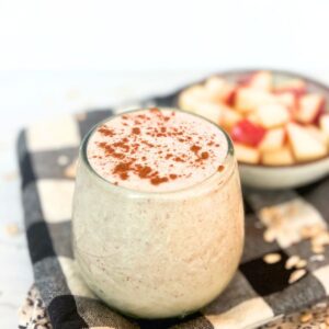 Close up photo of an apple smoothie topped with cinnamon.