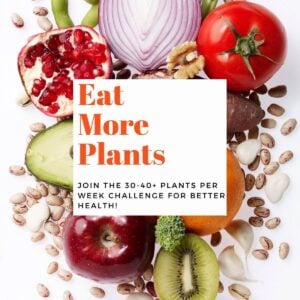 Colorful fruits and vegetables on a white background with text overlay-Eat More Plants.