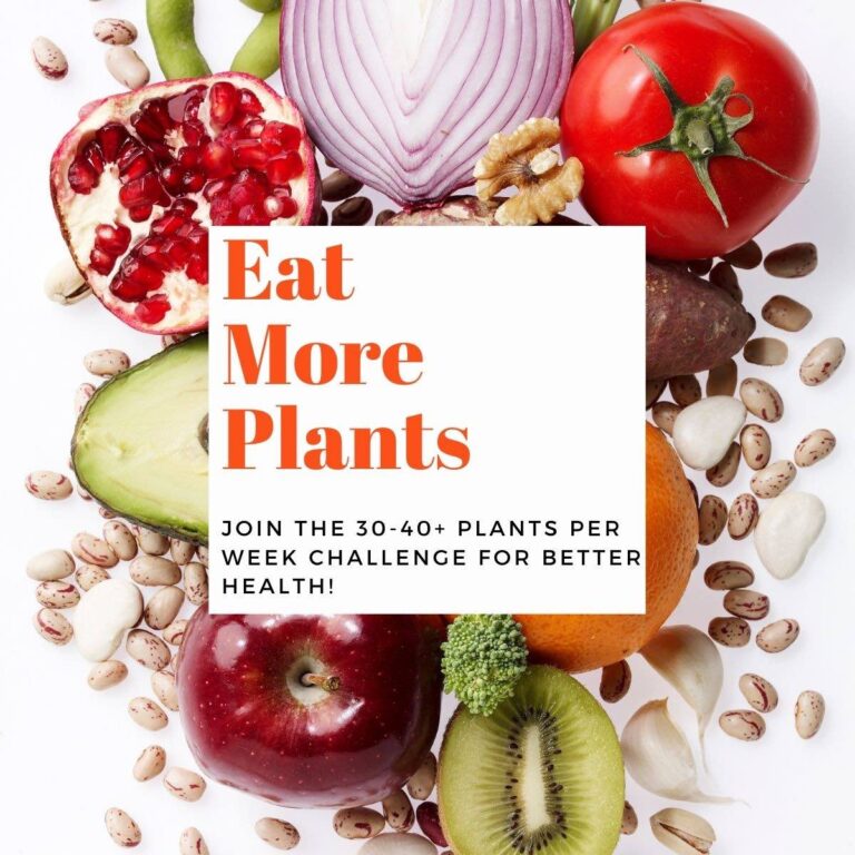 Colorful fruits and vegetables on a white background with text overlay-Eat More Plants.