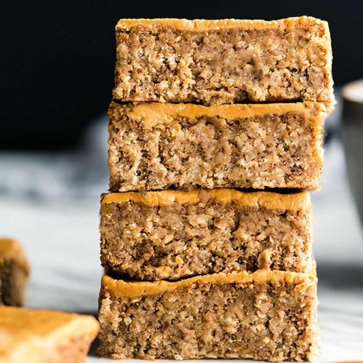 Four peanut butter bars stacked on top of each other.