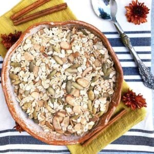 Ceramic bowl filled with gluten free muesli with pumpkin seeds and almonds.