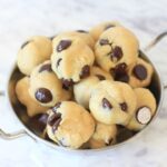 Chocolate chip energy bites in a metal bowl.