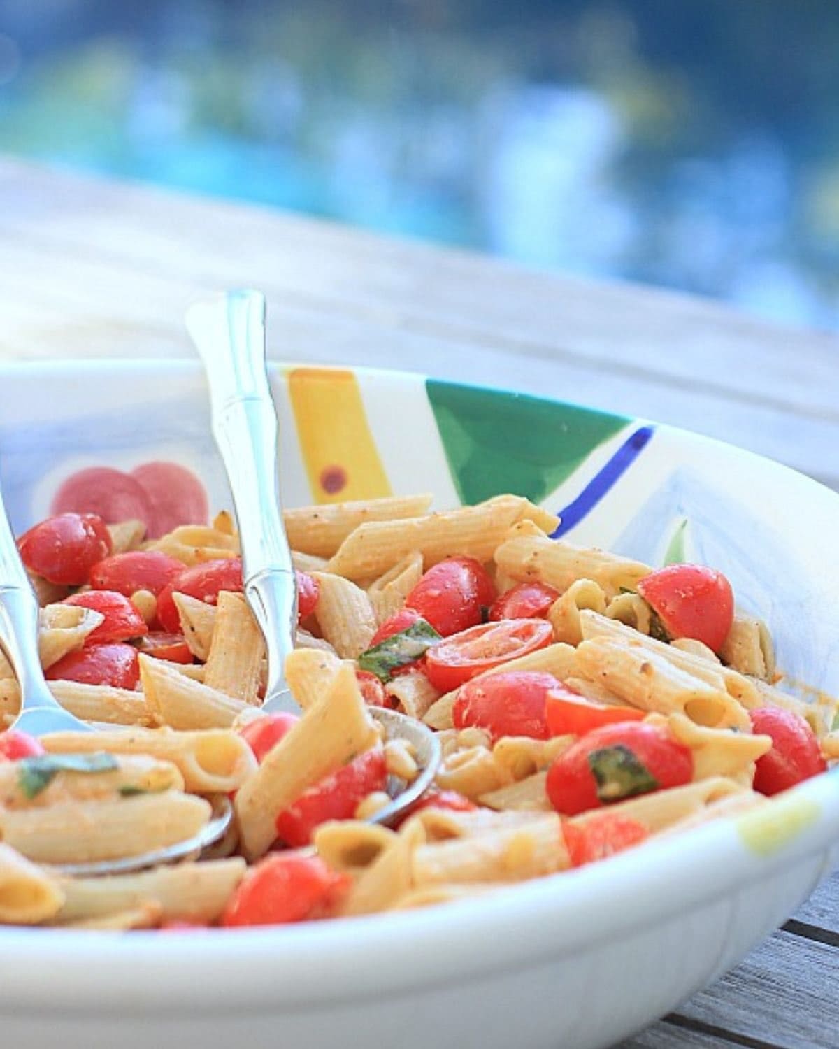 Close up photo of gluten free pasta salad in a colorful serving bowl.
