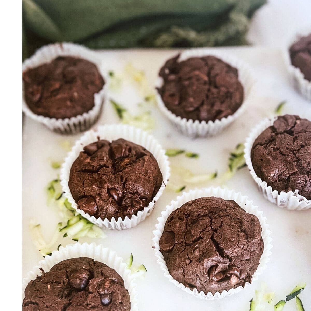 Chocolate muffins on a white marble tray.