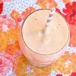 Close up photo of an immune boosting smoothie on a colorful orange and pink background.