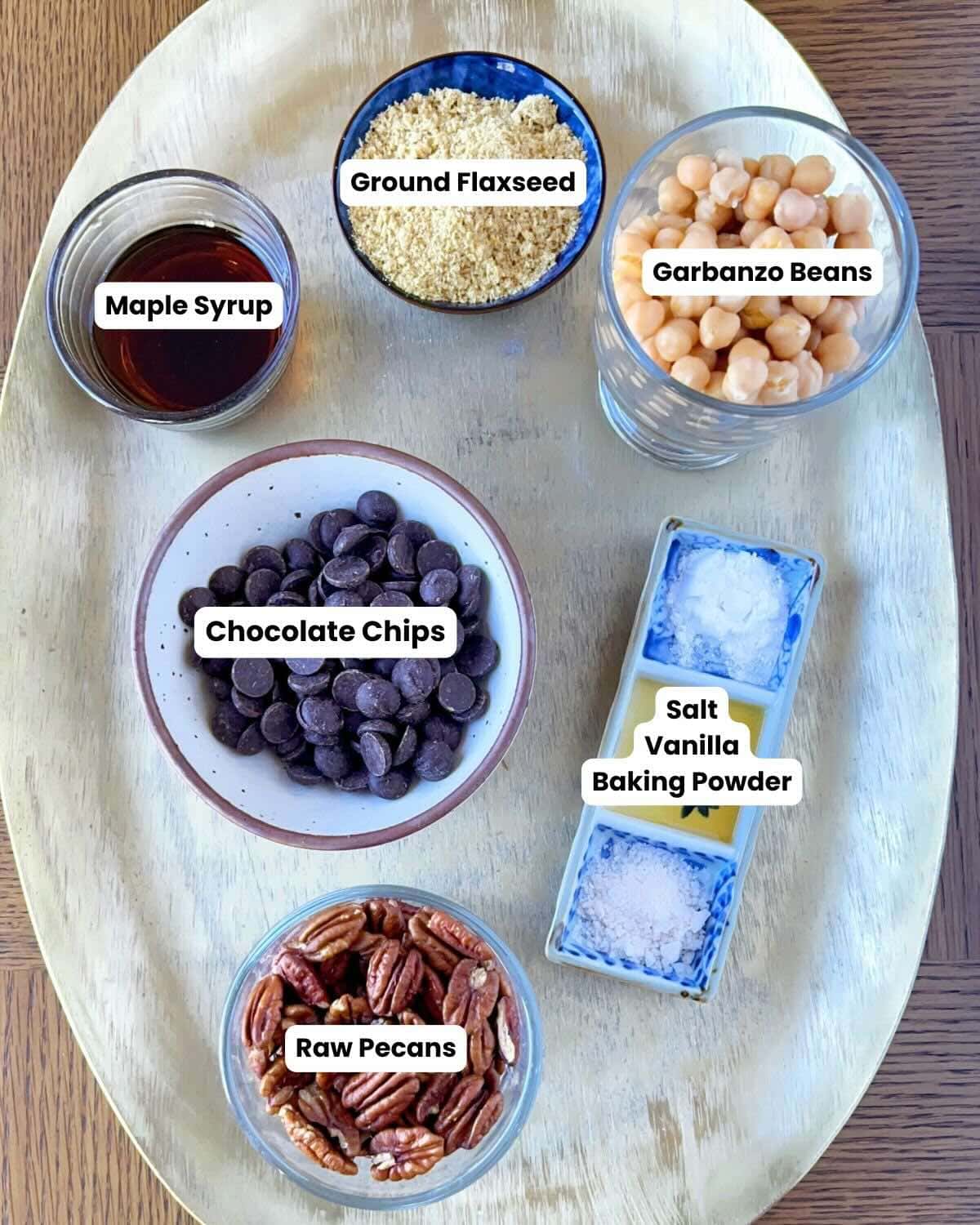 Ingredients on a gold tray to make chocolate chip chickpea cookies.