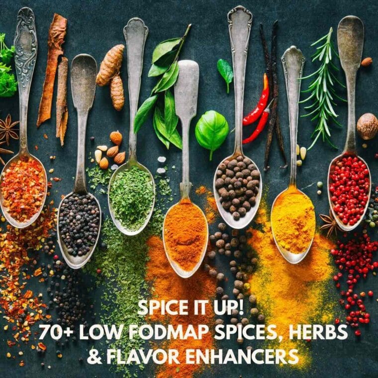 Multicolored spices on spoons, fresh herbs, and chili peppers on a black background.