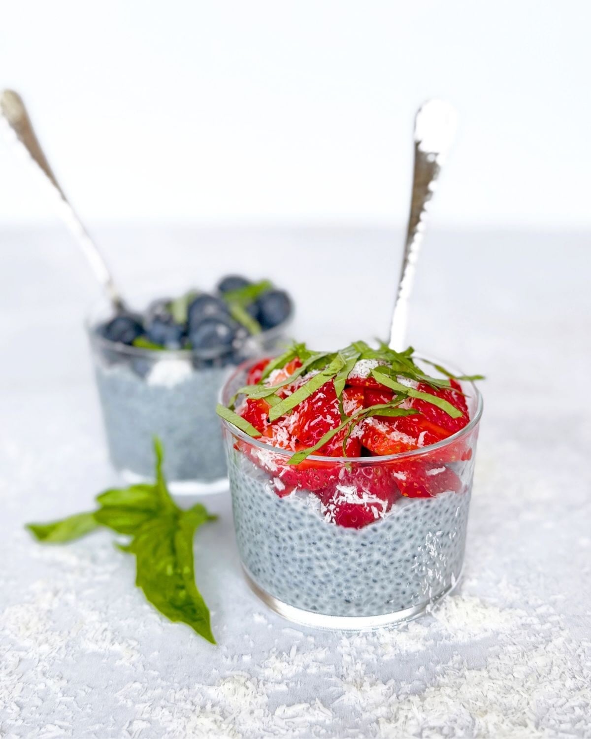 Close up photo of basil seed pudding topped with fruit.