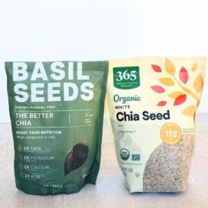 Side by side photos of basil seeds vs chia seeds.