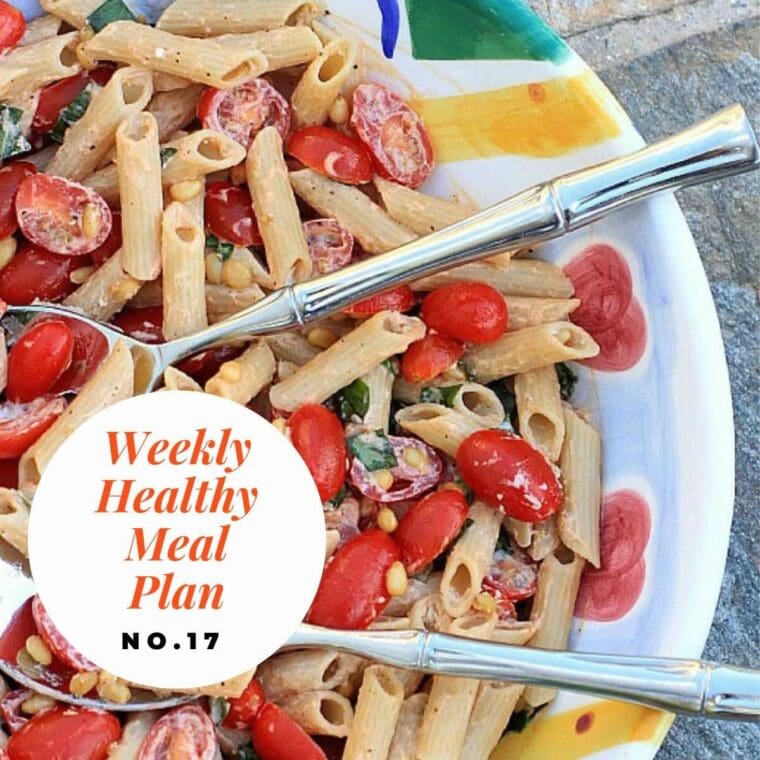 Close up photo of pasta salad with tomatoes and pine nuts.